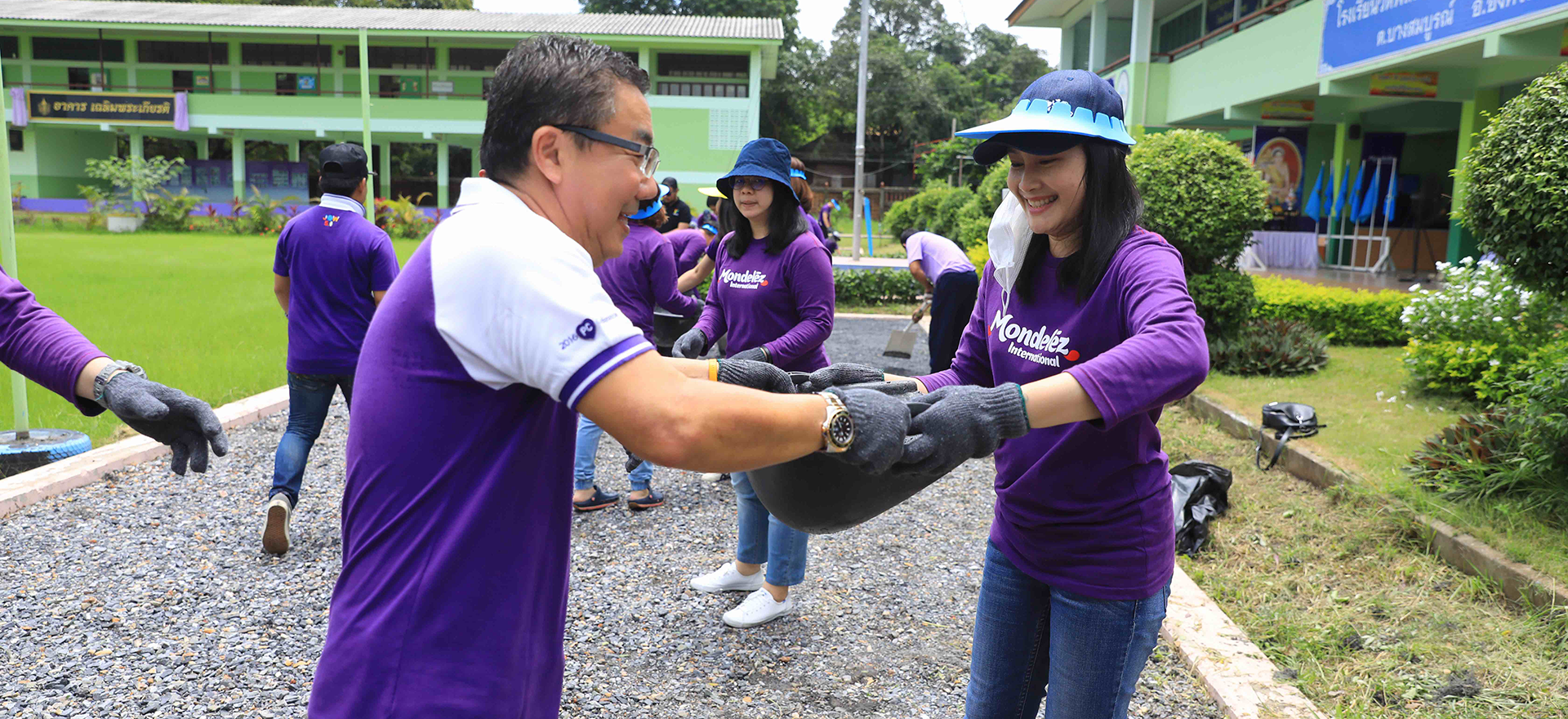 Mondelez employees in purple Mondelez shirts working outside.